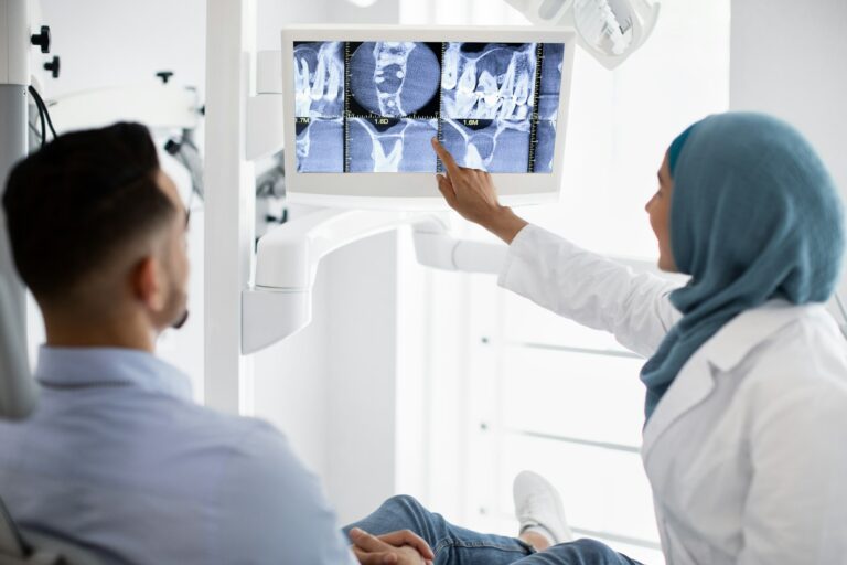 Root Canal Treatment. Muslim Female Dentist Showing Xray Picture On Digital Monitor